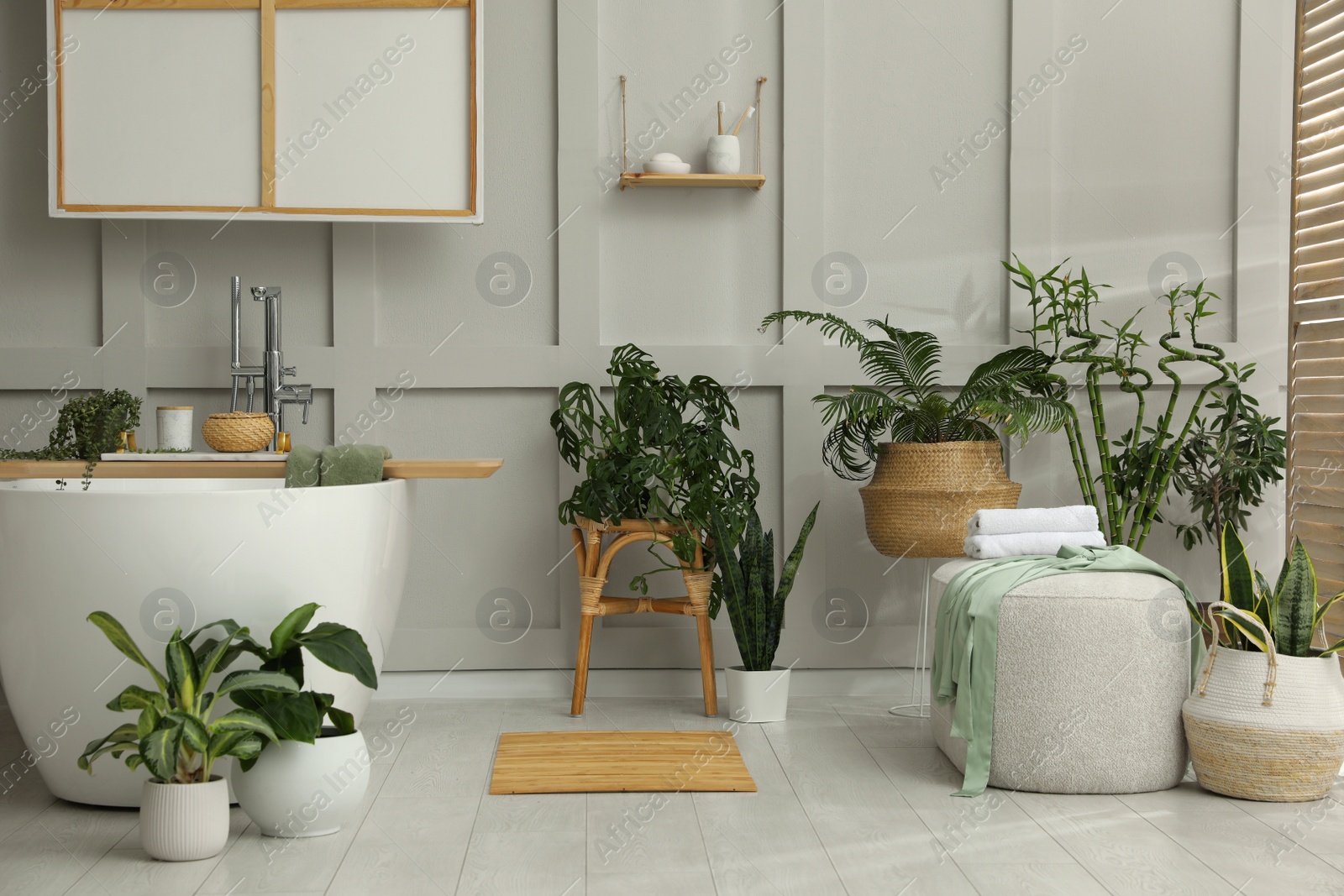 Photo of Stylish bathroom interior with green plants. Home design