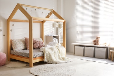 Photo of Cozy child room interior with comfortable bed