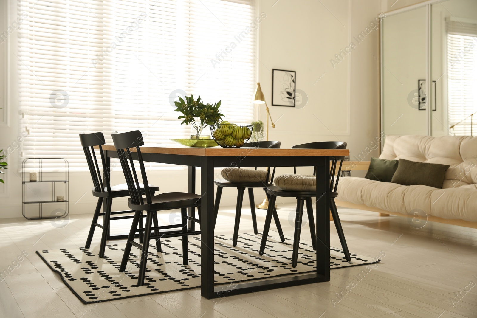 Photo of Stylish wooden dining table and chairs in room. Interior design