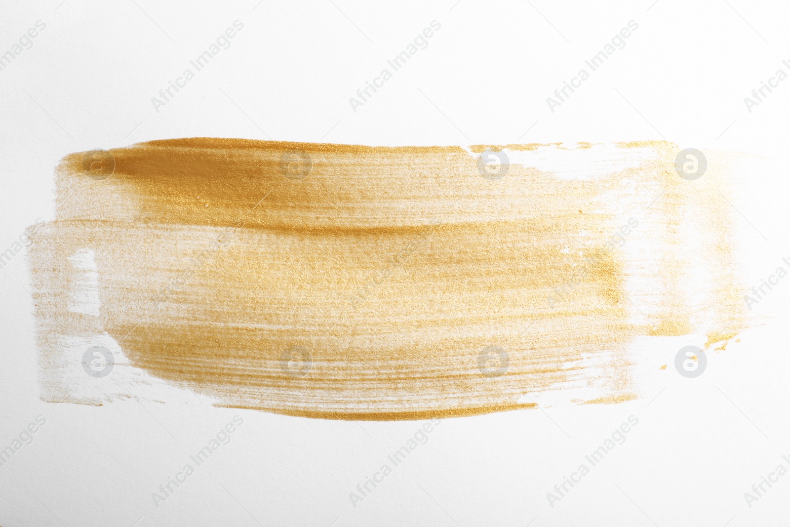 Photo of Strokes of gold paint isolated on white, top view