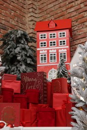 Christmas trees, gift boxes and festive decor indoors. Interior design