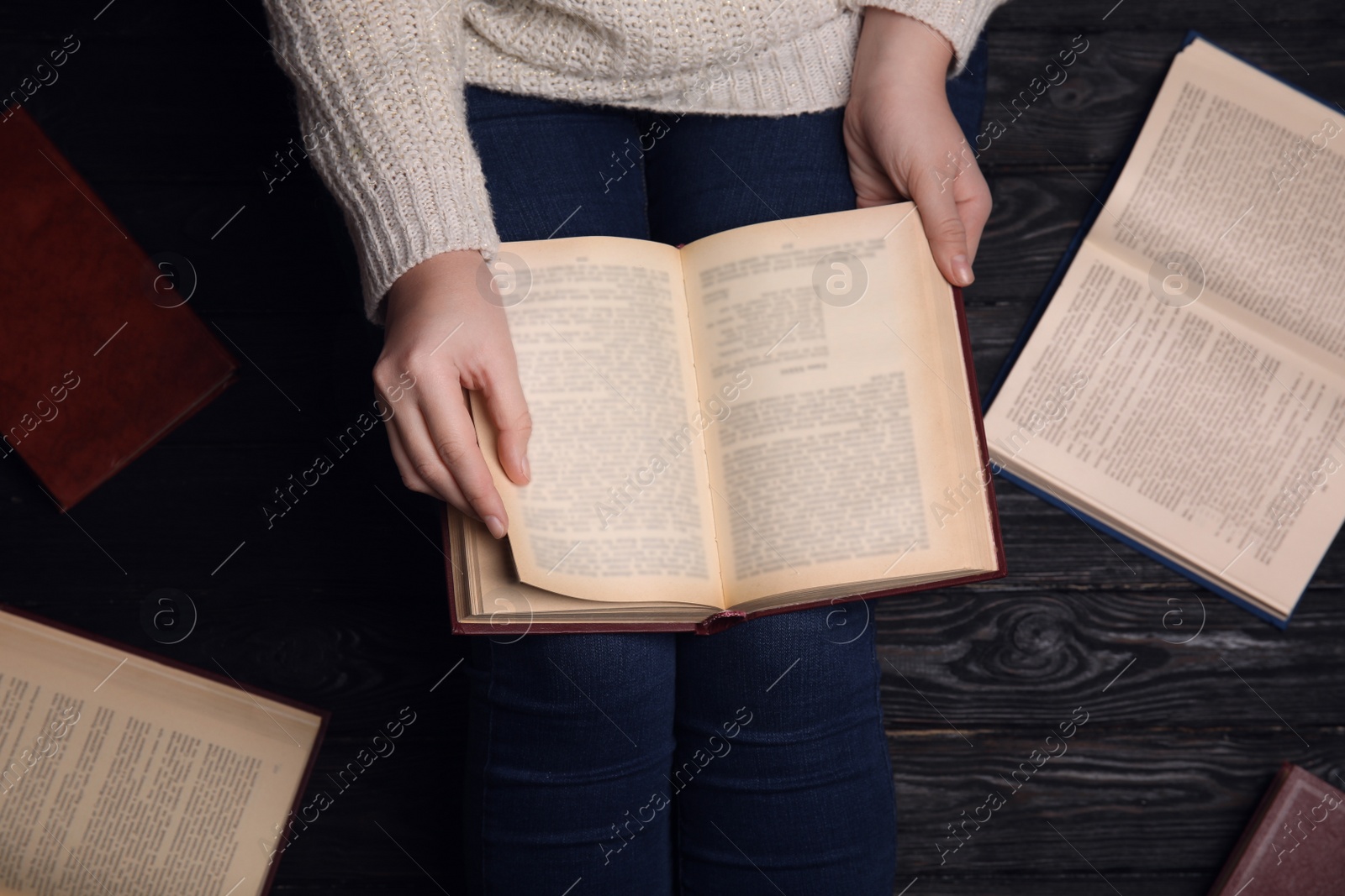 Photo of Woman reading book at home, top view