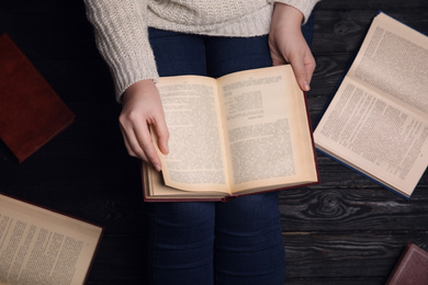 Photo of Woman reading book at home, top view