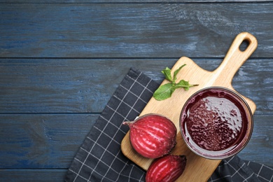 Photo of Flat lay composition with fresh beet juice on blue wooden table. Space for text