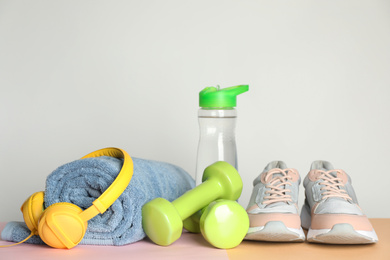 Photo of Composition with fitness equipment and headphones on table