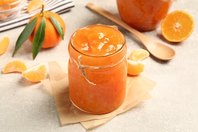 Delicious tangerine jam on light grey table