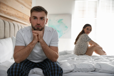 Photo of Young couple quarreling at home. Jealousy in relationship