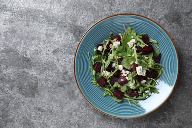 Fresh delicious beet salad on grey table, top view. Space for text