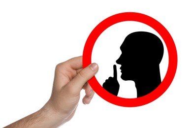 Image of Quiet Please. Man holding sign with shush gesture image on white background, closeup