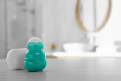 Deodorant container on table in bathroom. Space for text