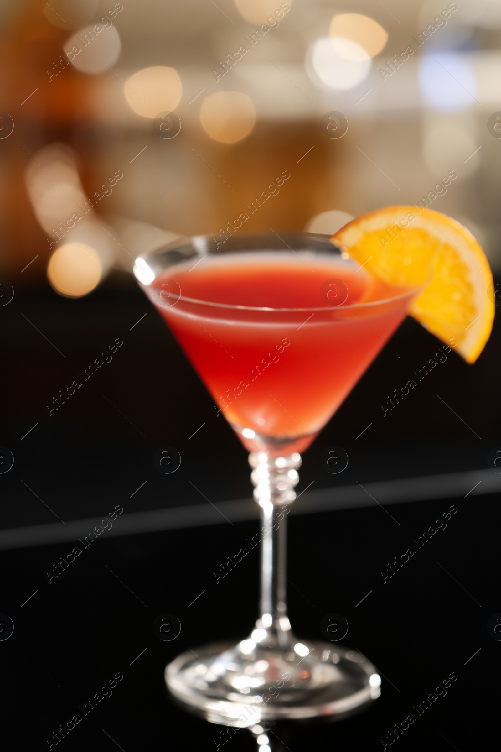 Photo of Delicious cocktail with orange on bar counter