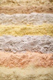 Photo of Different types of flours as background, closeup