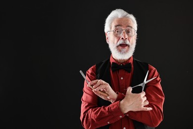 Photo of Senior man with mustache holding blade and scissors on black background, space for text