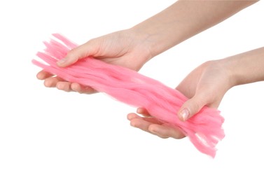 Woman holding pink felting wool on white background, closeup