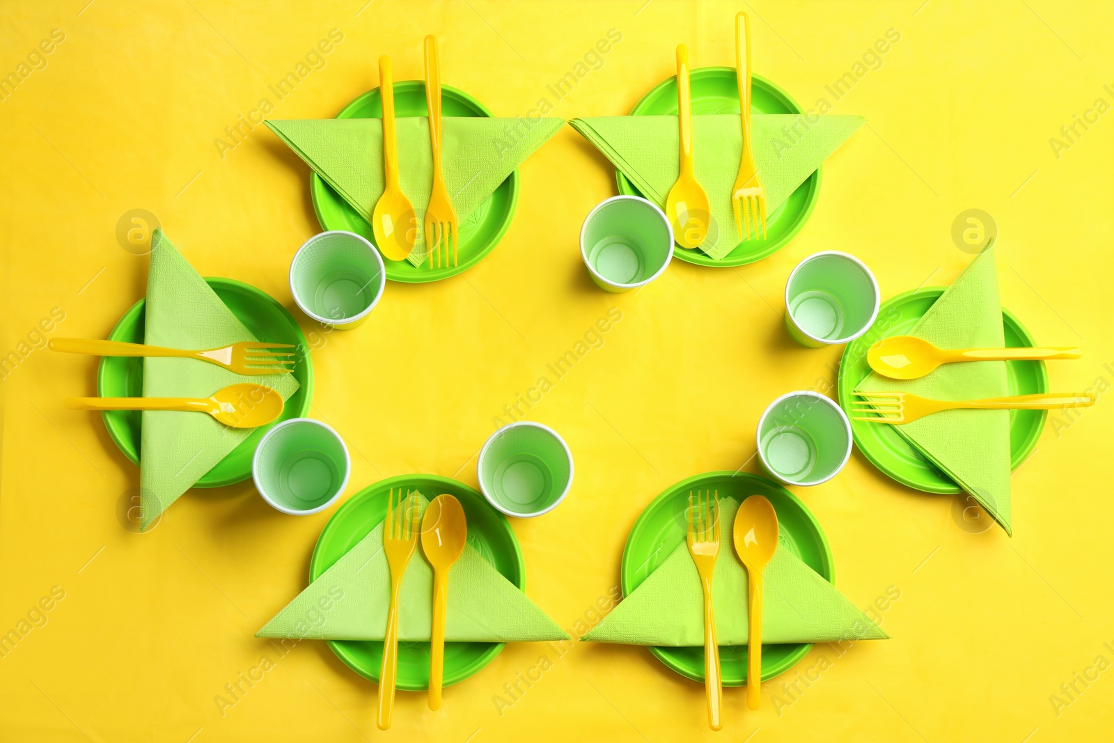 Photo of Table setting with plastic dishware on color background, top view