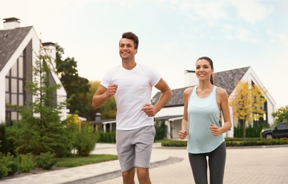 Photo of Sporty couple running on street. Healthy lifestyle