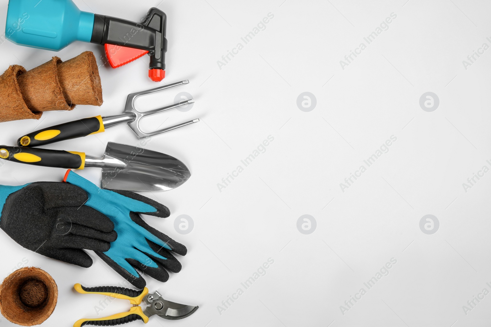 Photo of Flat lay composition with gardening tools on white background, space for text