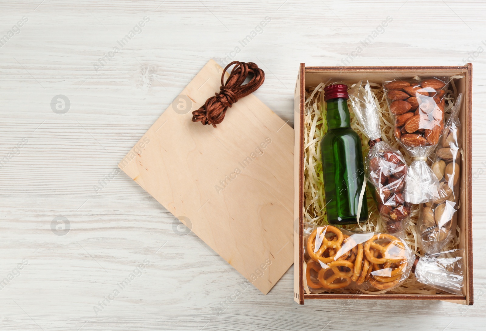 Photo of Stylish gift set on white wooden table, flat lay. Space for text