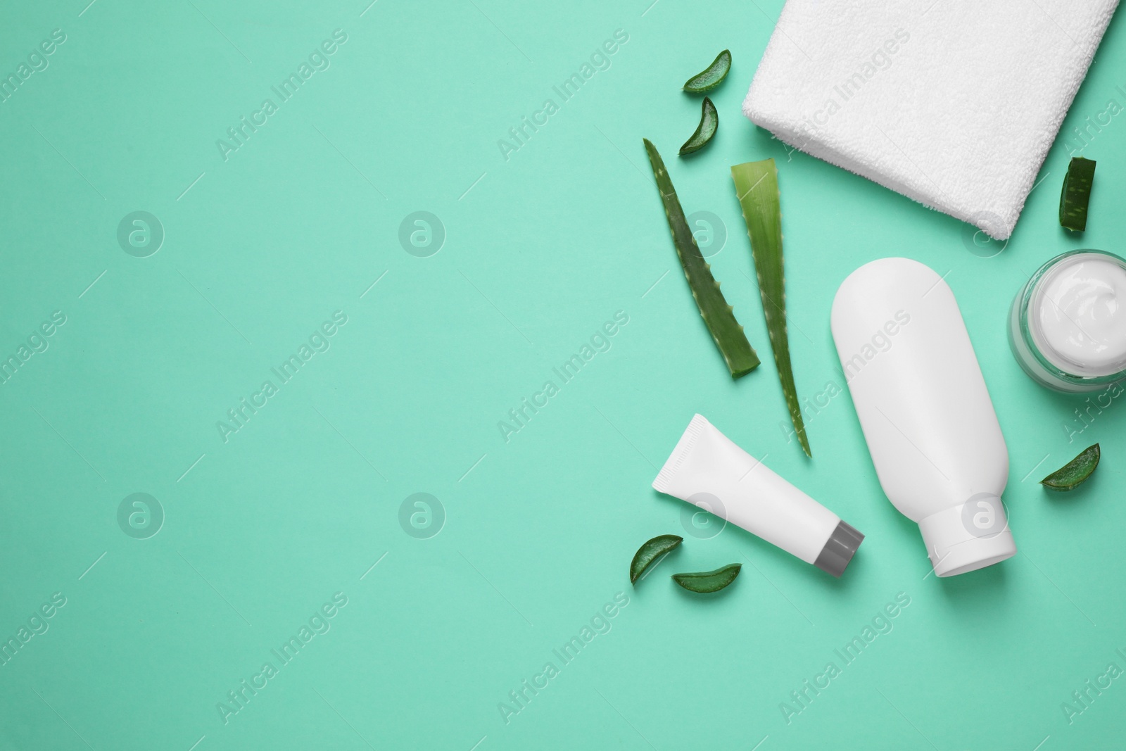 Photo of Flat lay composition with aloe vera and cosmetic products on turquoise background. Space for text