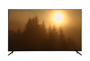 Image of Modern wide screen TV monitor showing foggy forest at sunrise isolated on white