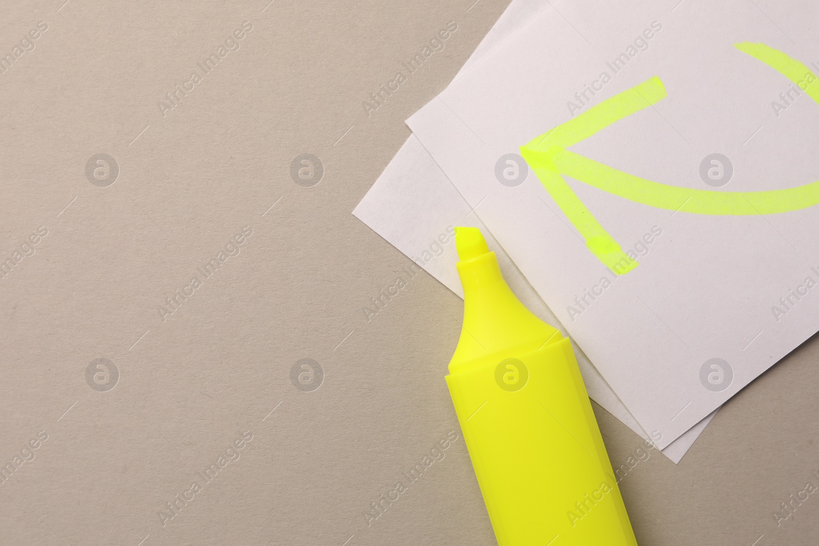 Photo of Bright yellow marker and sticky note with drawn arrow on light grey background, flat lay. Space for text