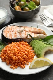 Photo of Healthy food high in vegetable fats on grey table, closeup