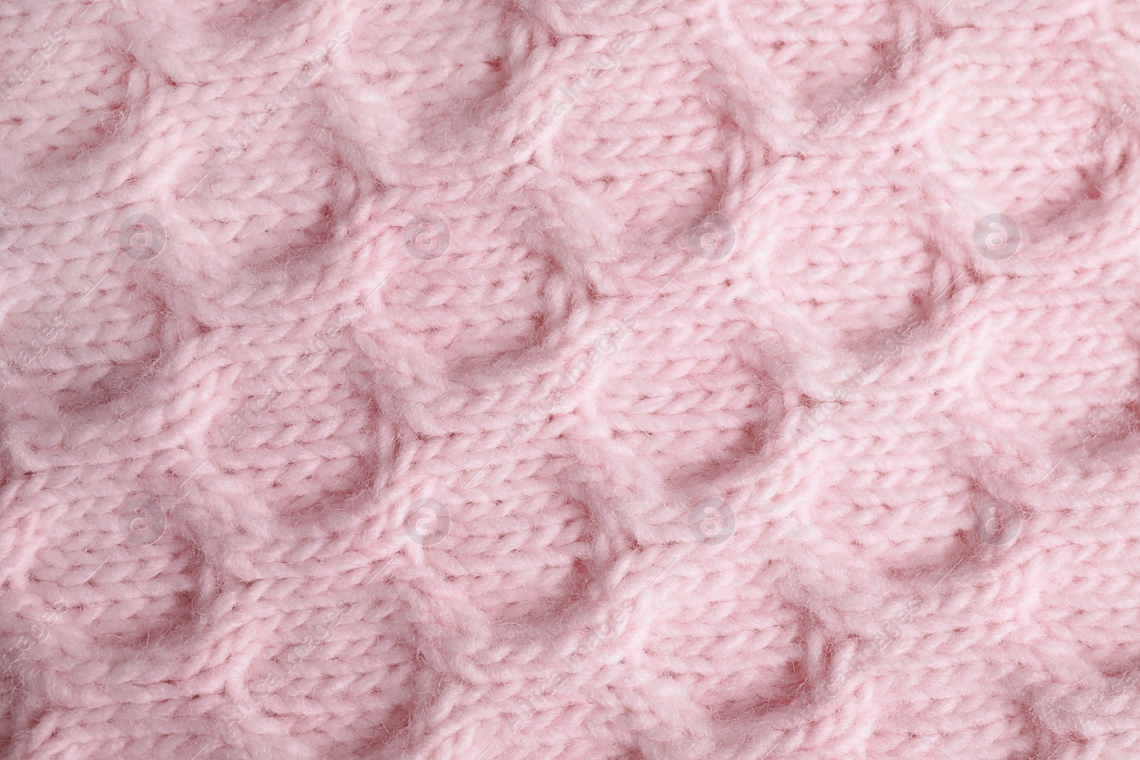 Photo of Pink knitted sweater as background, closeup view