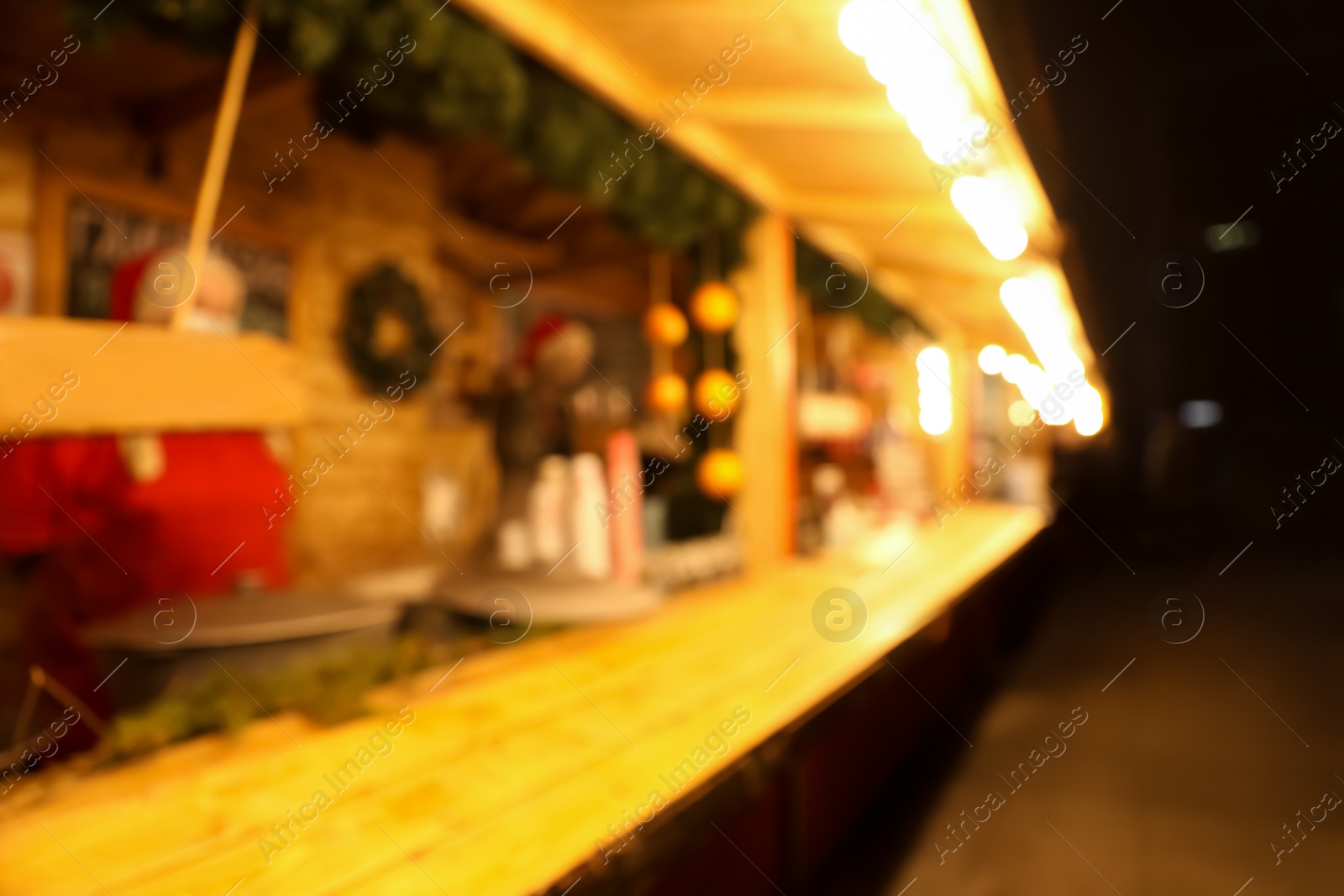 Photo of Blurred view of Christmas fair stall outdoors at night