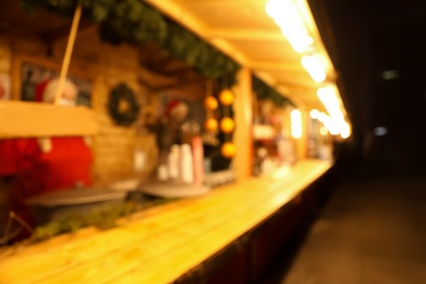 Blurred view of Christmas fair stall outdoors at night