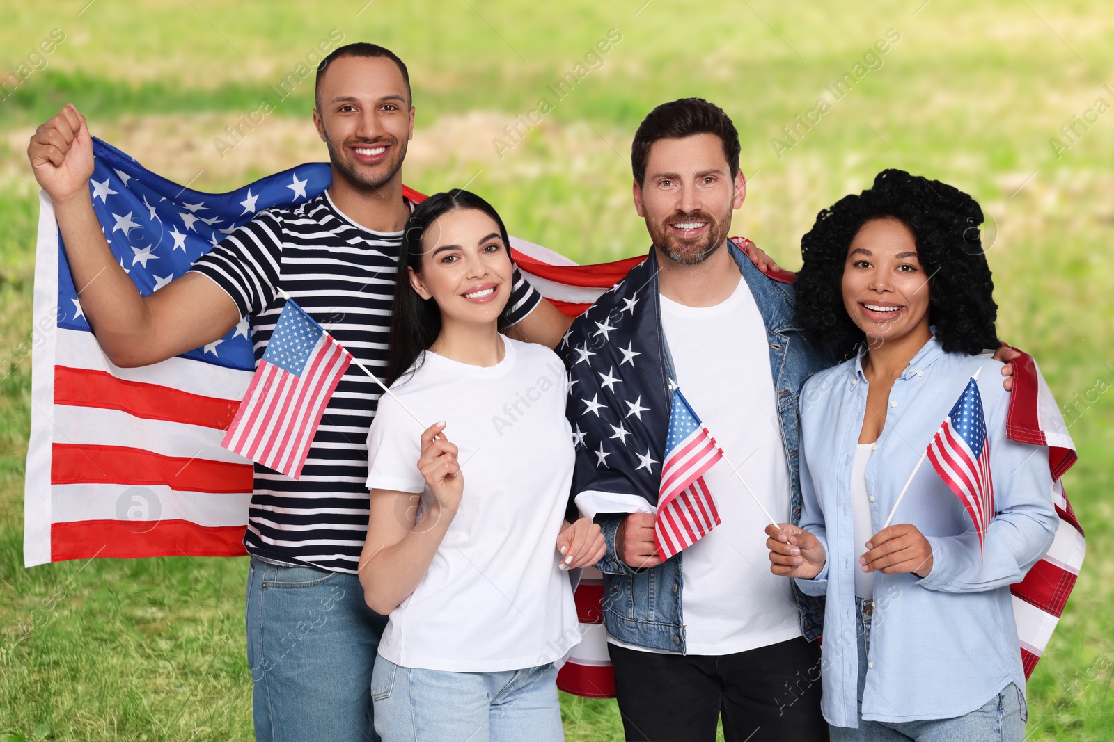 Image of 4th of July - Independence day of America. Happy friends with national flags of United States in park