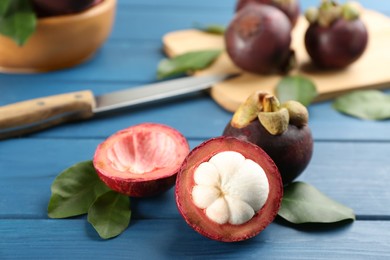 Delicious tropical mangosteens on blue wooden table