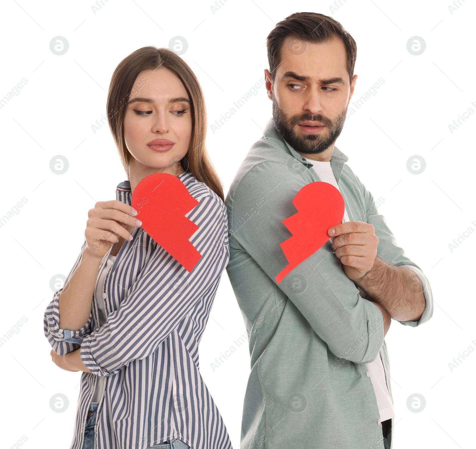 Photo of Couple with torn paper heart on white background. Relationship problems