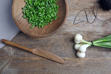 Photo of Beautiful composition with fresh green onion on table, top view