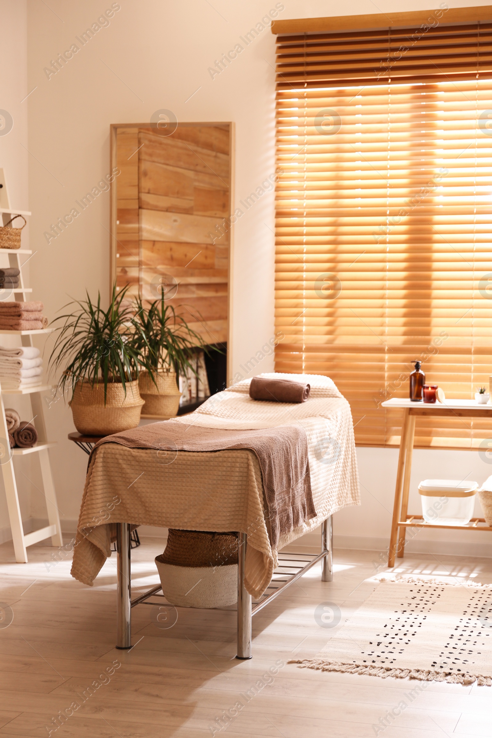 Photo of Stylish massage room interior in spa salon