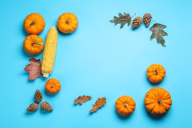 Photo of Thanksgiving day. Flat lay composition with pumpkins on light blue background, space for text