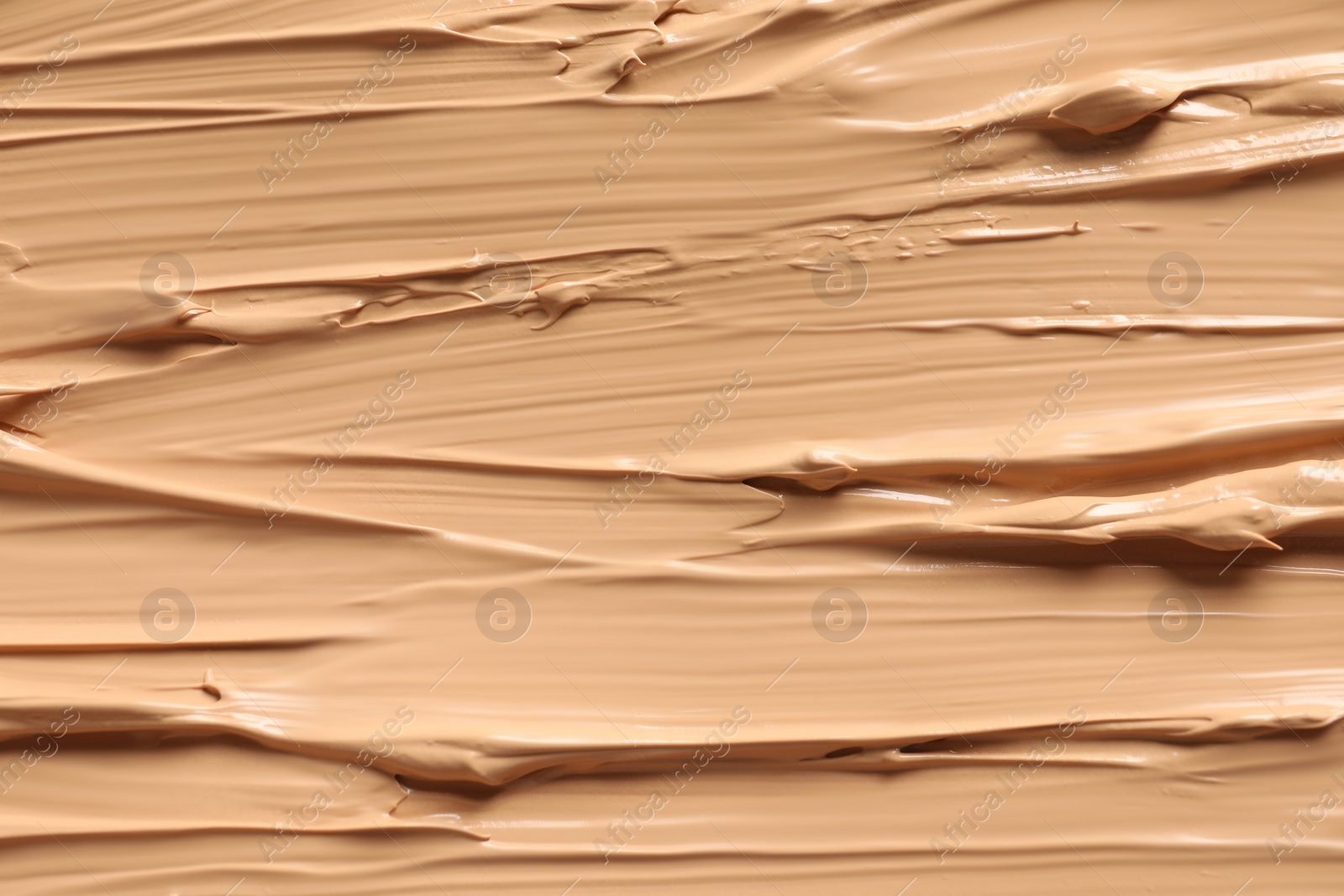 Photo of Texture of skin foundation as background, closeup