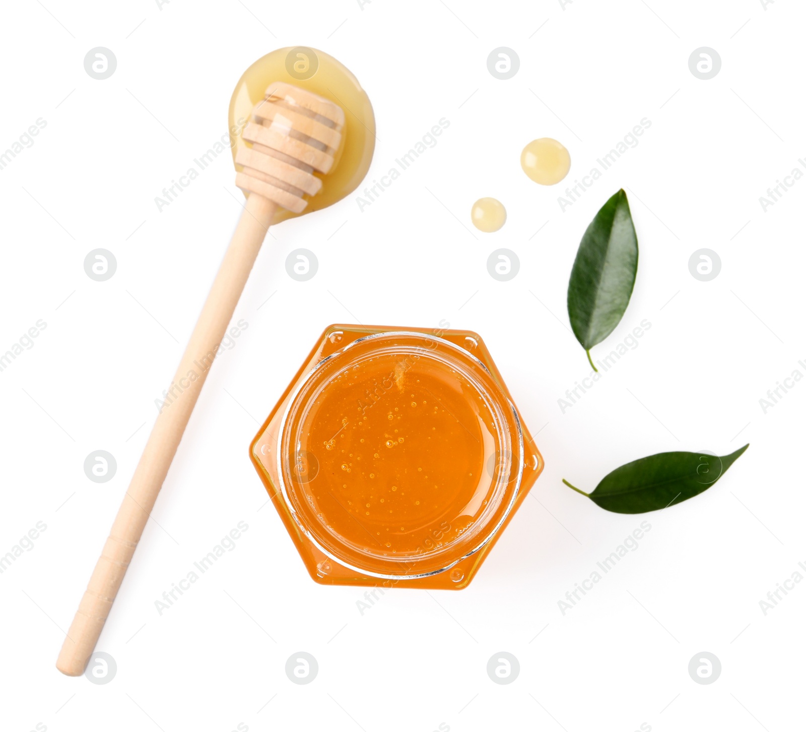 Photo of Tasty honey in glass jar, dipper and leaves isolated on white, top view