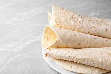 Photo of Corn tortillas on light background, closeup with space for text. Unleavened bread
