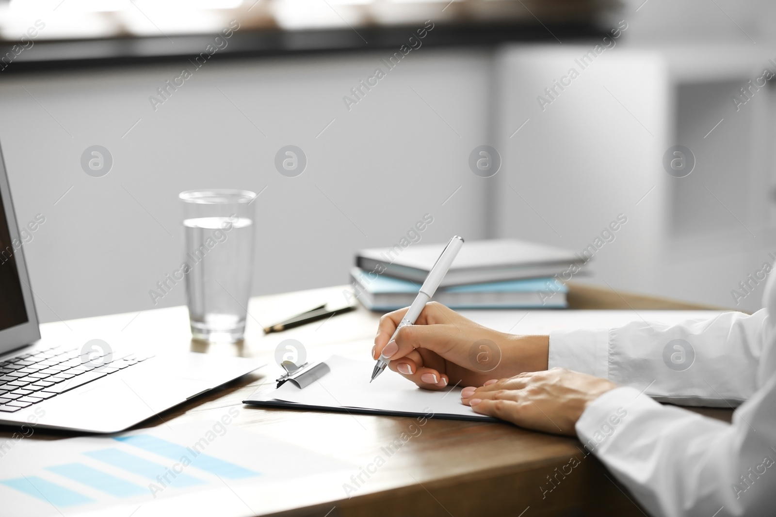 Photo of Business trainer working at table in office, closeup