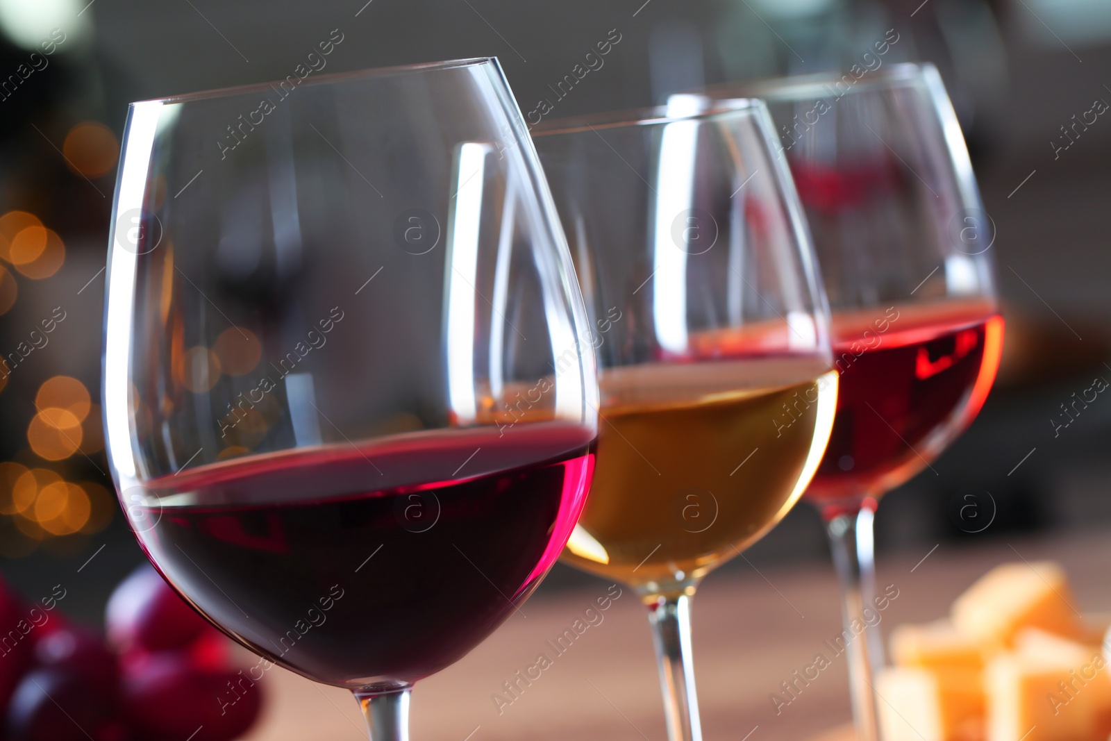 Photo of Glasses with different wines on blurred background, closeup