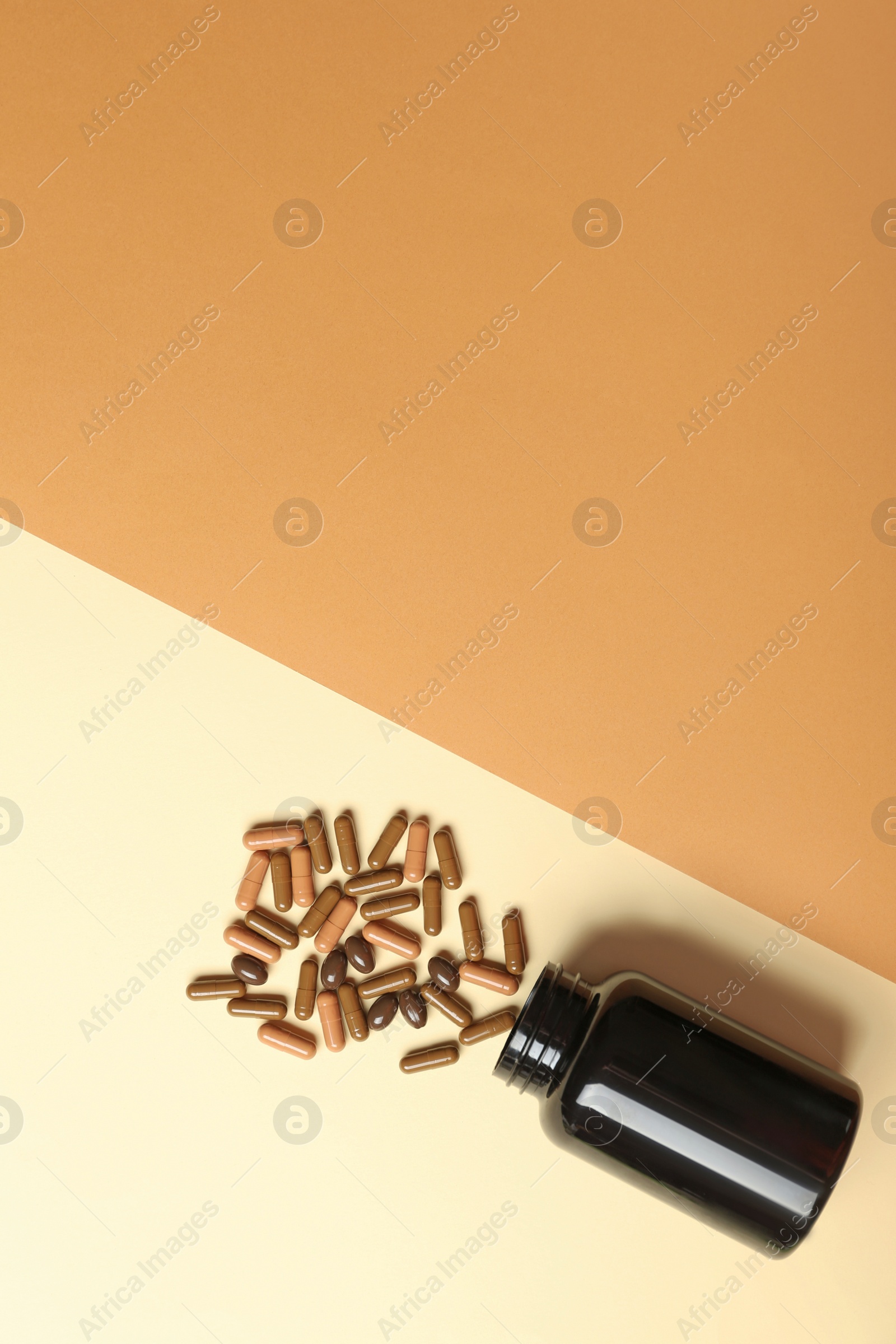 Photo of Bottle with vitamin capsules on color background, flat lay. Space for text