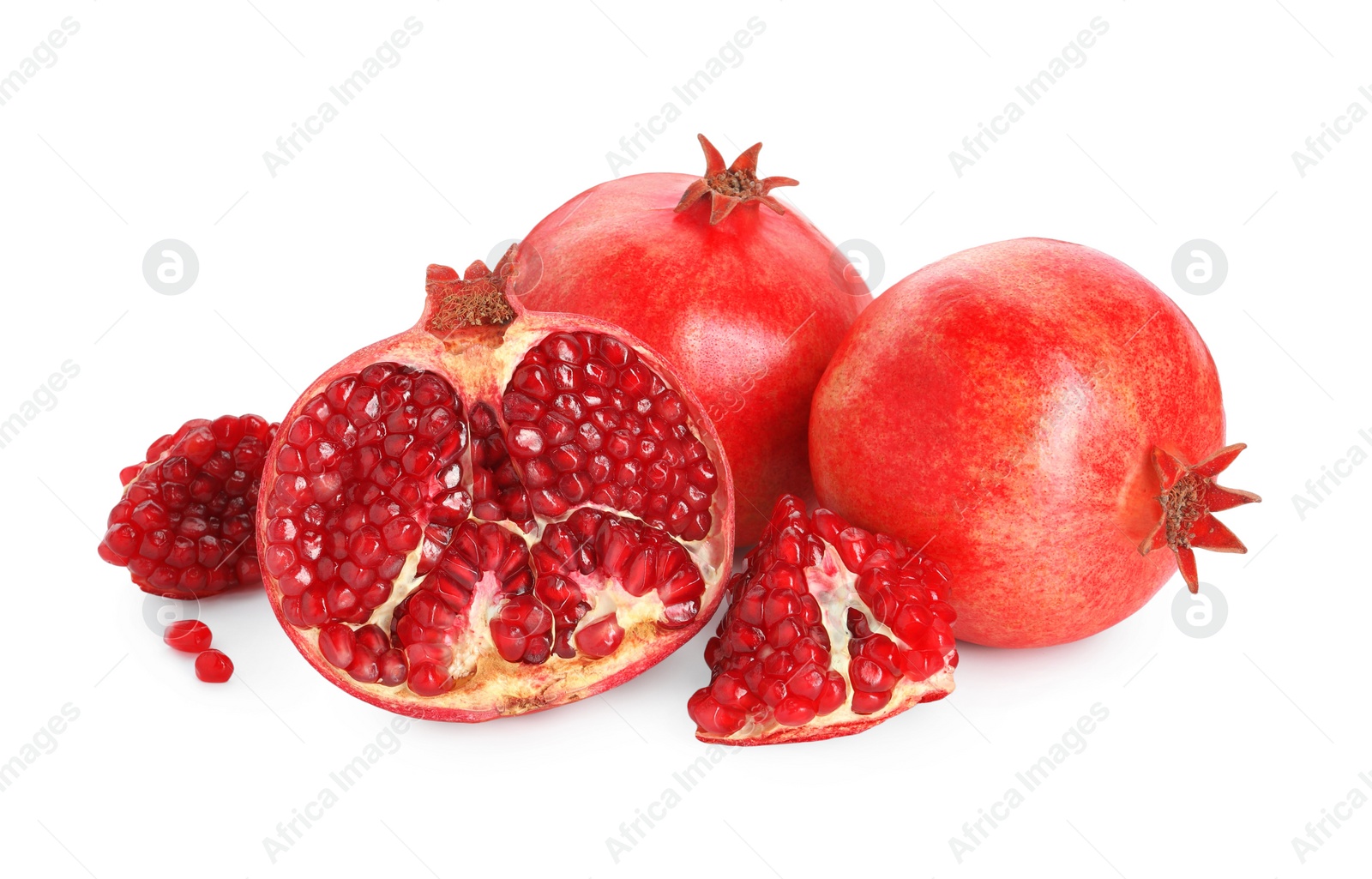 Photo of Cut and whole pomegranates isolated on white