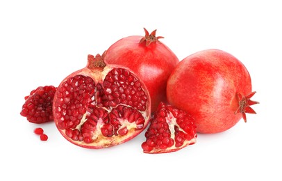 Cut and whole pomegranates isolated on white