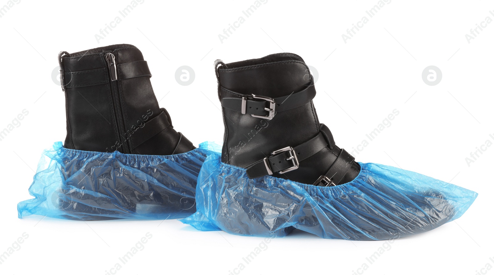 Photo of Women's boots in blue shoe covers isolated on white