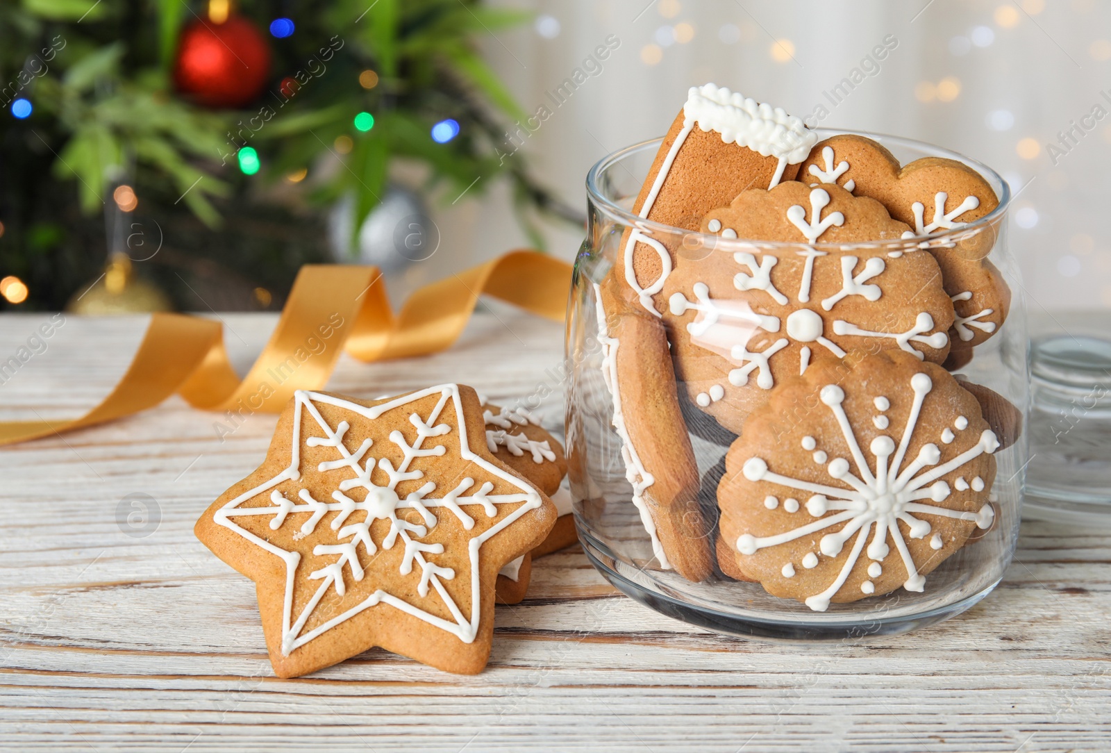 Photo of Glass jar with tasty homemade Christmas cookies on table