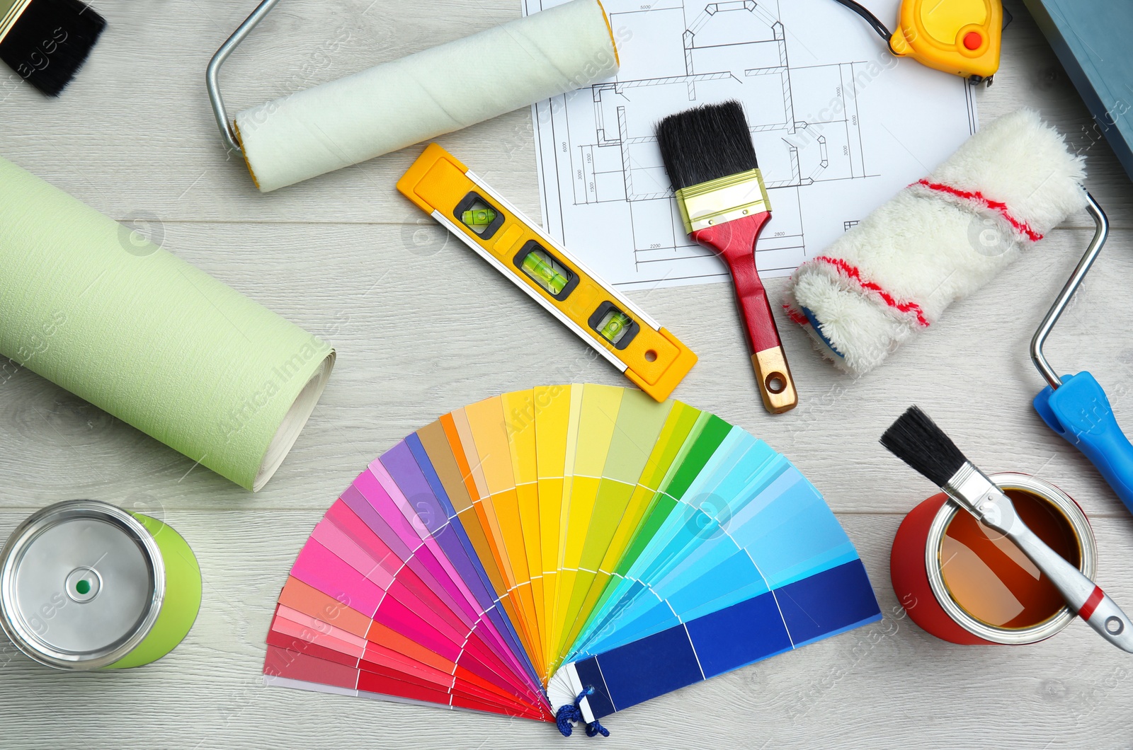 Photo of Set of decorator's tools on wooden floor