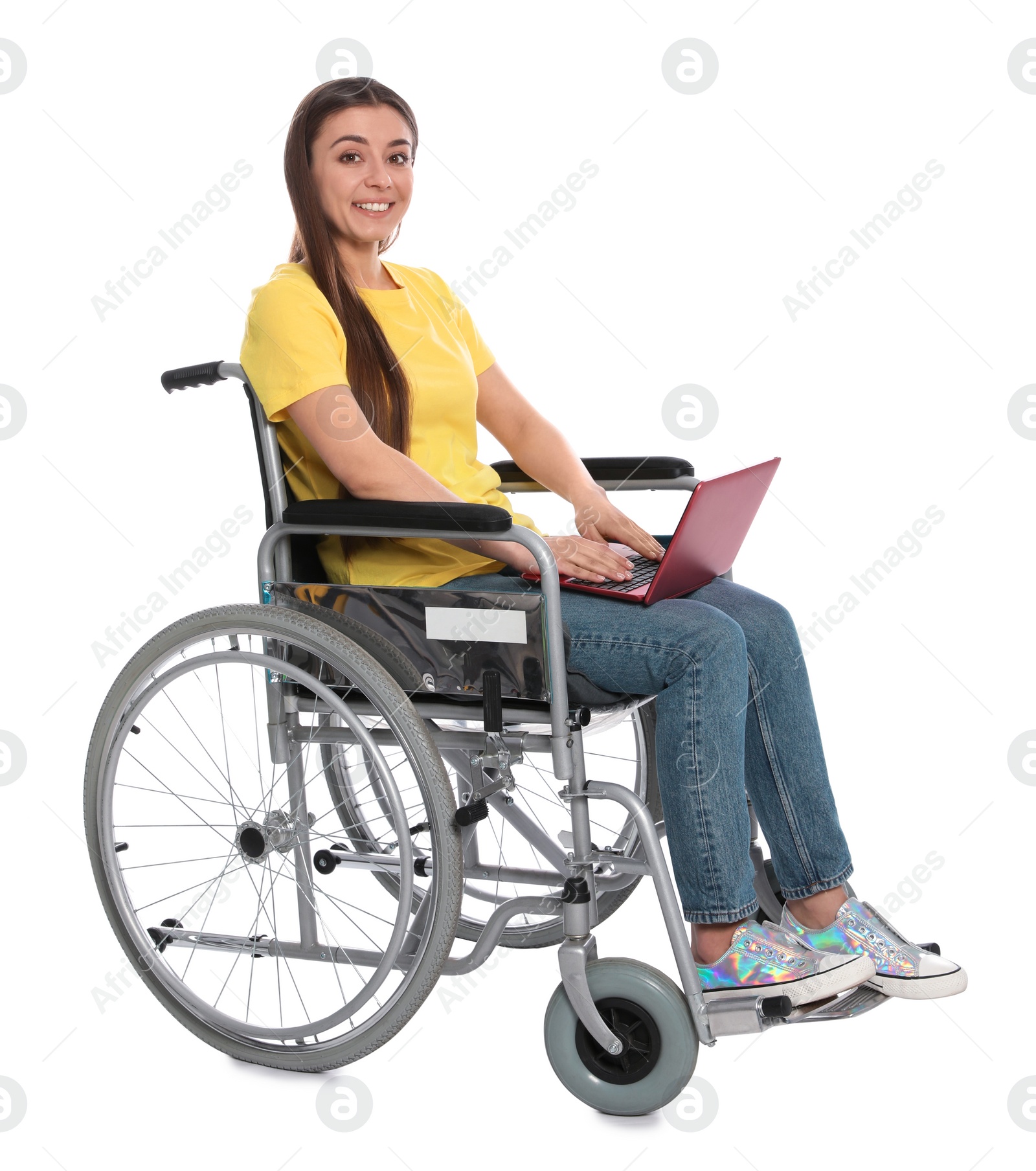 Photo of Young woman in wheelchair with laptop isolated on white