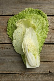 Photo of Cut fresh Chinese cabbage on wooden table, top view