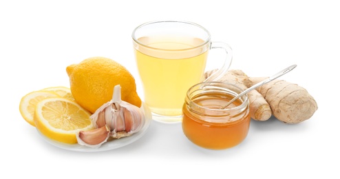 Cup with hot tea and other cold remedies on white background