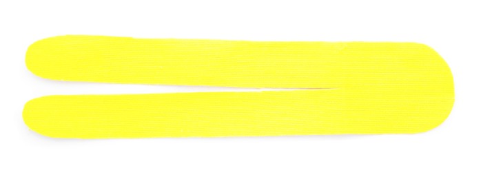 Yellow kinesio tape piece on white background, top view